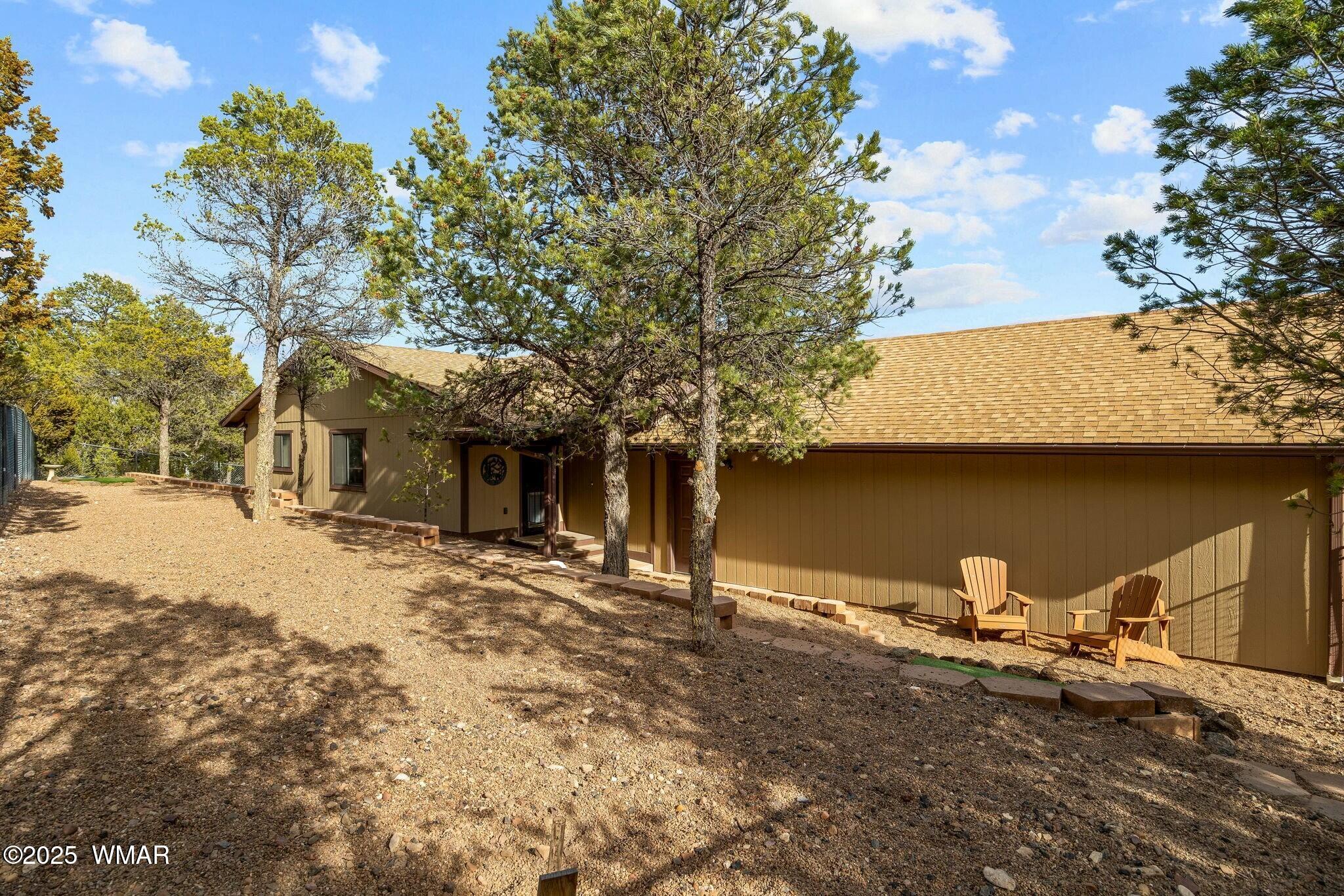 2938 Lodgepole Road Overgaard, AZ 85933 - Photo 31 of 43 a front view of a house with yard