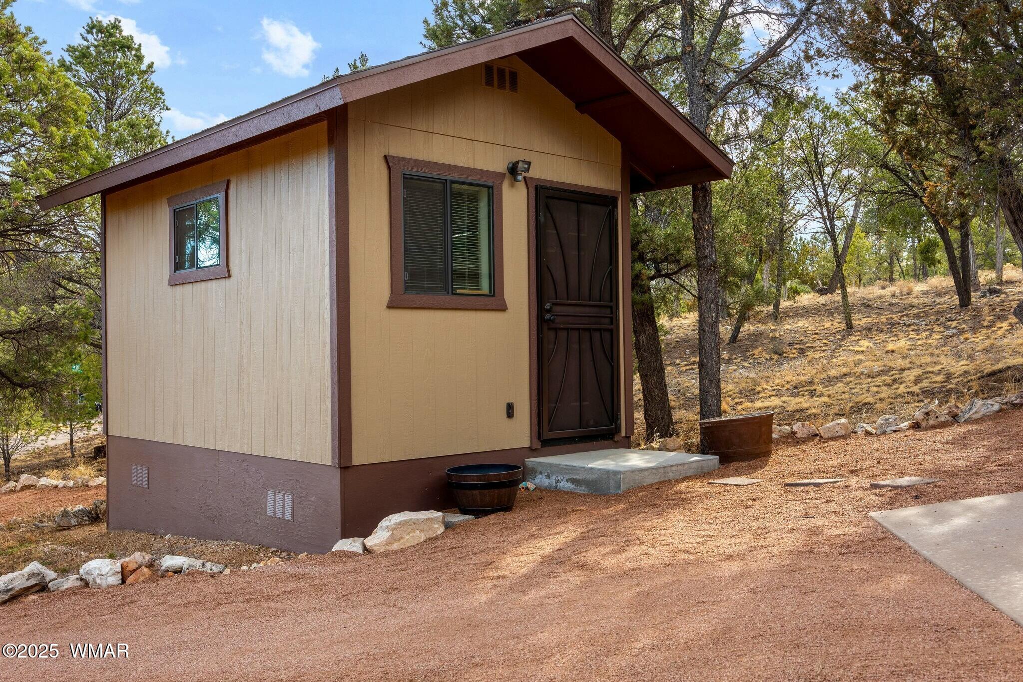 2938 Lodgepole Road Overgaard, AZ 85933 - Photo 32 of 43 a view of a house with a yard