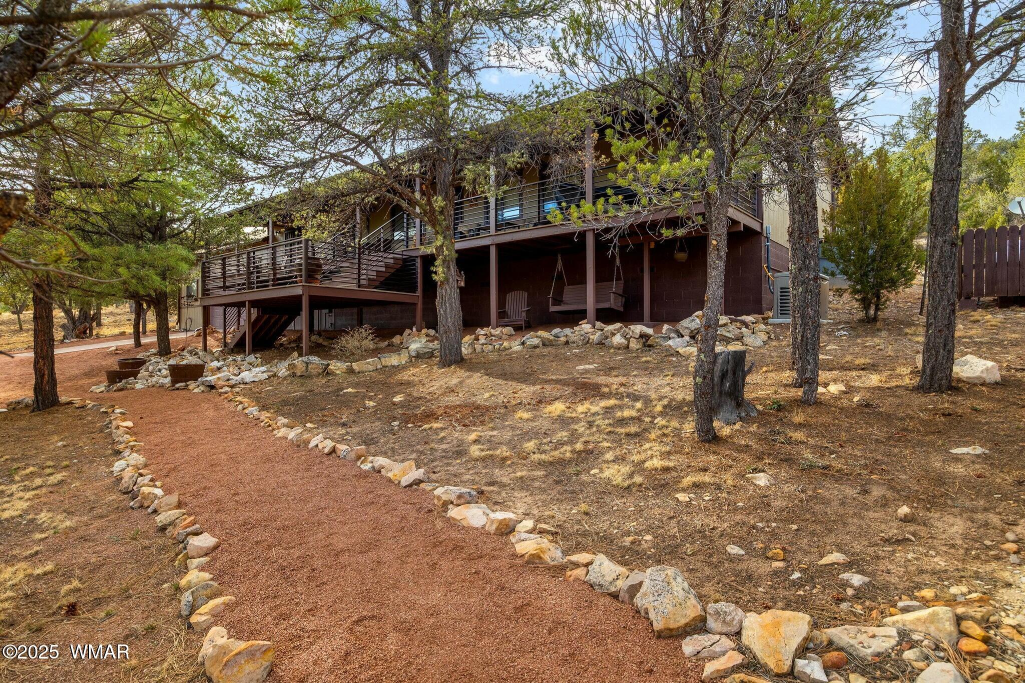 2938 Lodgepole Road Overgaard, AZ 85933 - Photo 4 of 43 a front view of a house with a tree in it