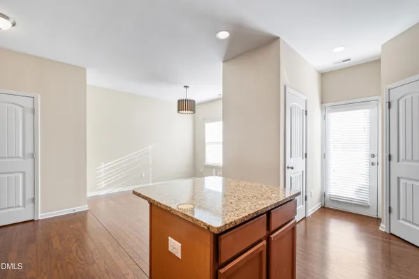 an empty room with wooden floor and window