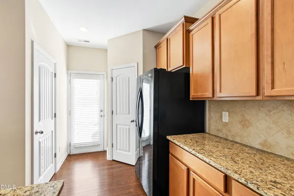 a kitchen with stainless steel appliances granite countertop a refrigerator and a sink