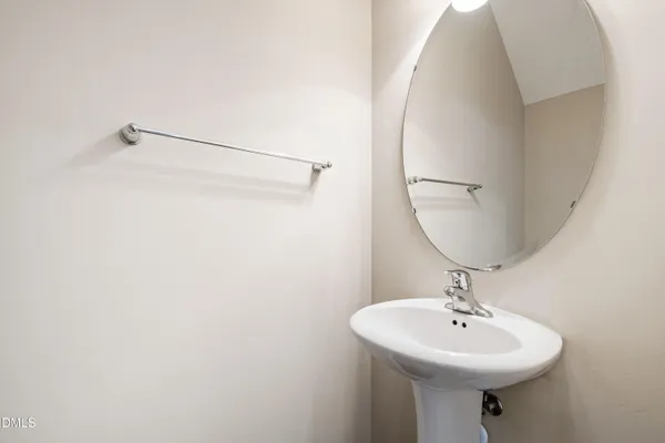 a bathroom with a sink a mirror and vanity