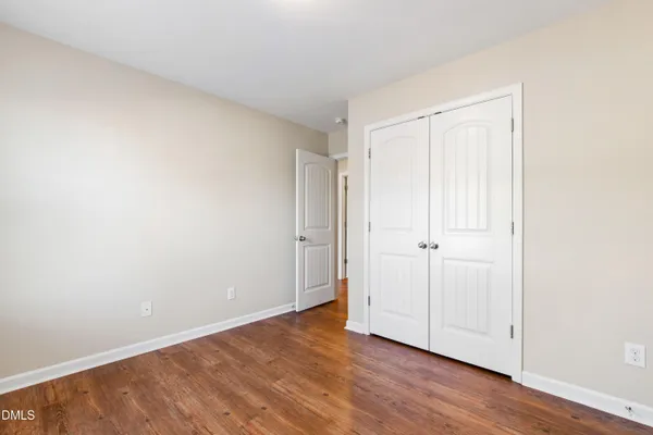 a view of an empty room and wooden floor