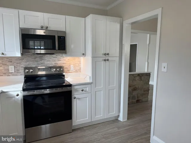 a kitchen with cabinets and steel stainless steel appliances
