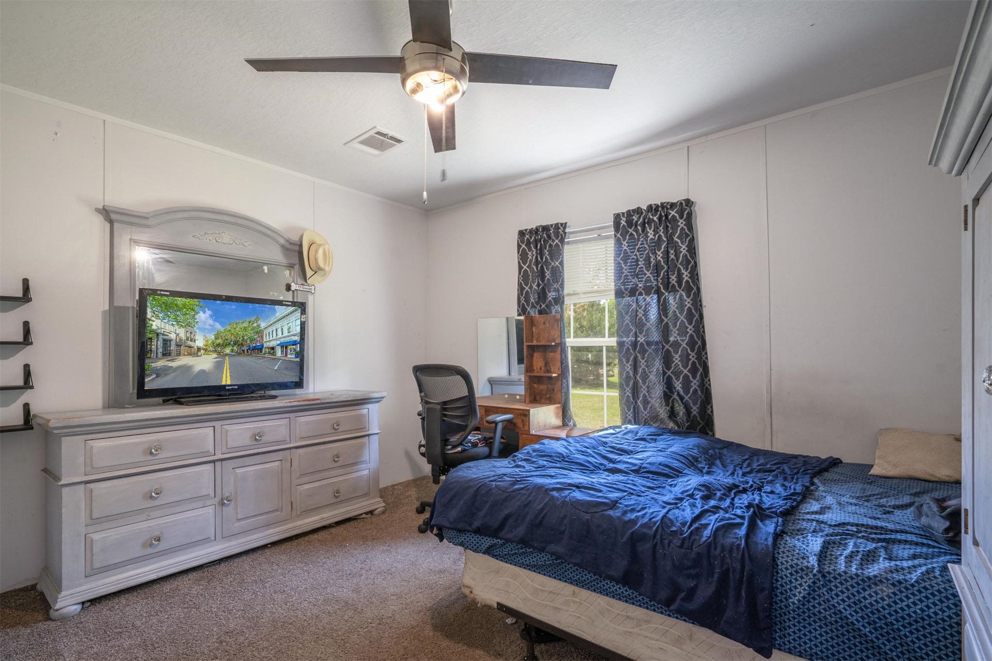 76220 Dove Road Yulee, FL 32097 - Photo 36 of 48 a bedroom with a bed and a flat screen tv