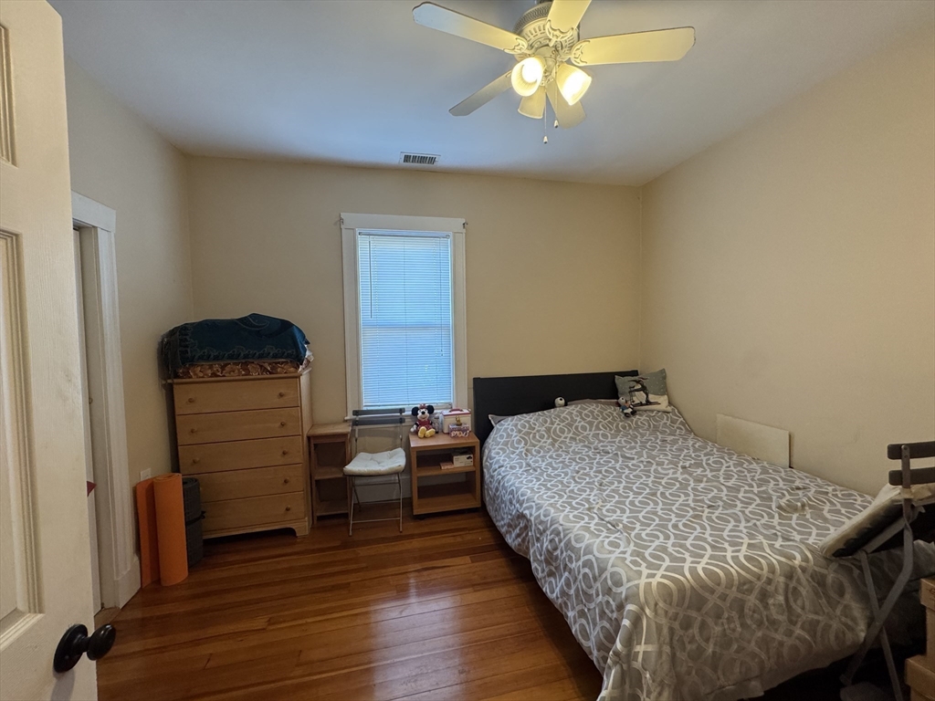 28 Quirk Street, Unit 28 Watertown, MA 02472 - Photo 11 of 23 a bedroom with a bed and wooden floor