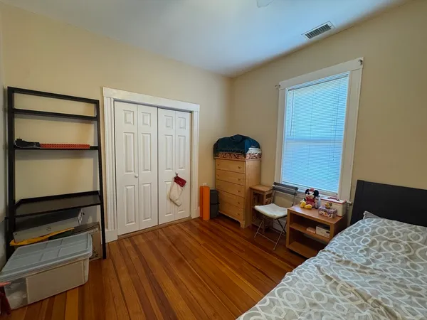 a bedroom with bed and a dresser