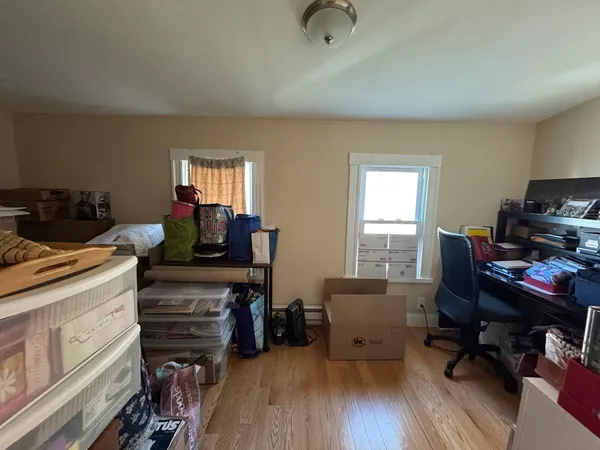a view of a workspace with furniture and a window