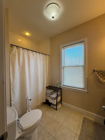 a bathroom with a toilet a sink and a mirror