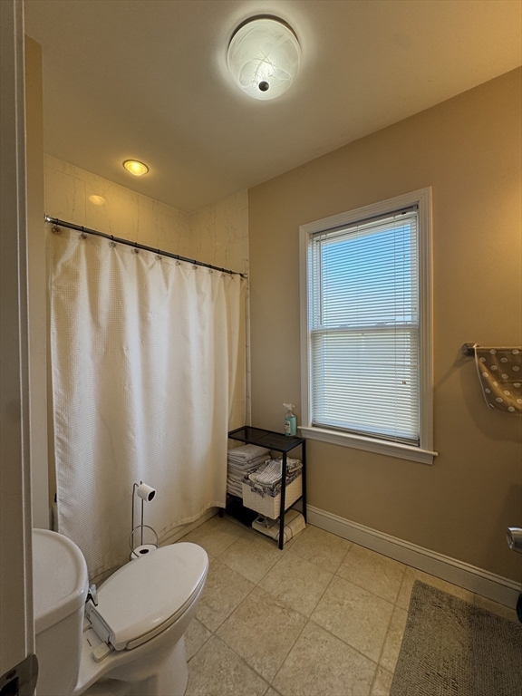 28 Quirk Street, Unit 28 Watertown, MA 02472 - Photo 14 of 23 a bathroom with a toilet a sink and a mirror