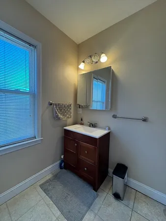 a bathroom with a sink vanity and mirror