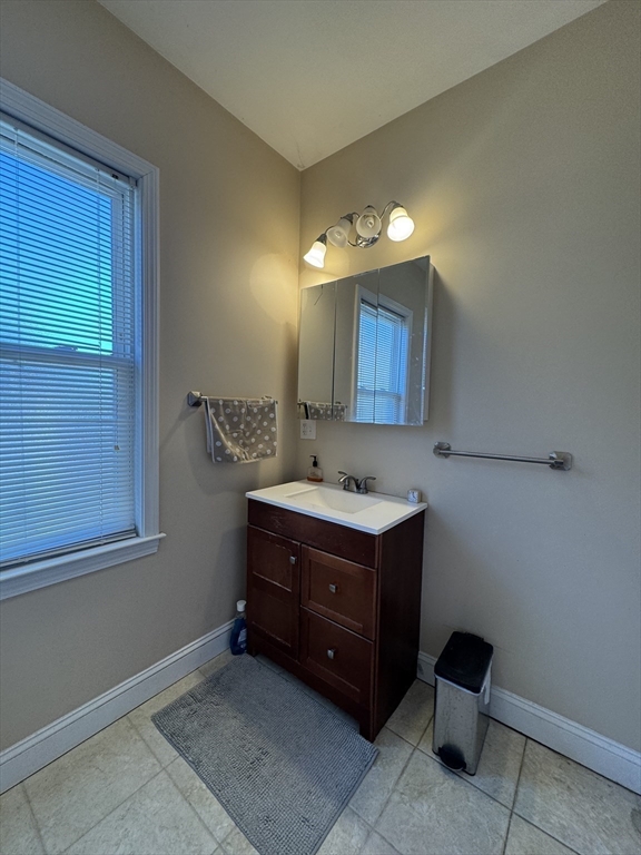 28 Quirk Street, Unit 28 Watertown, MA 02472 - Photo 15 of 23 a bathroom with a sink vanity and mirror