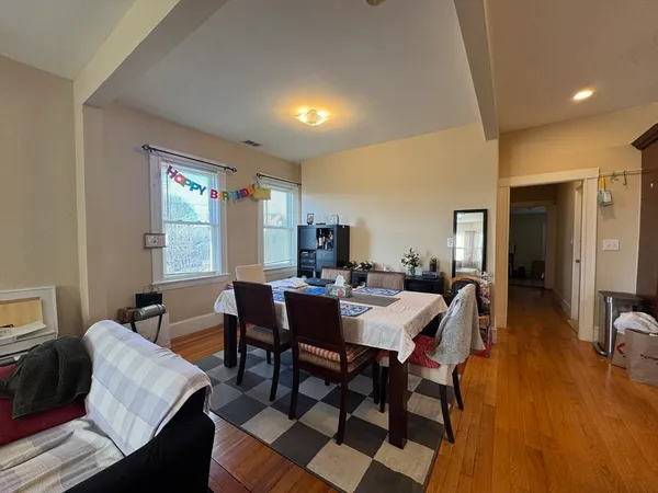 a view of a dining room with furniture and wooden floor