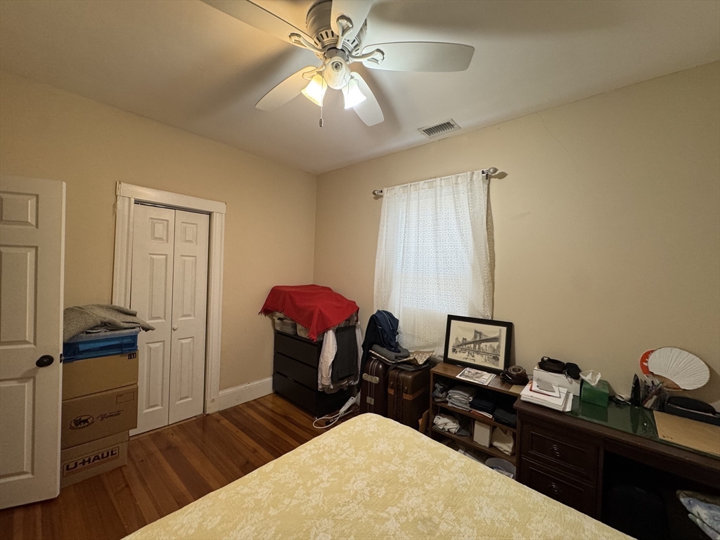 28 Quirk Street, Unit 28 Watertown, MA 02472 - Photo 9 of 23 a bedroom with a bed and a chandelier