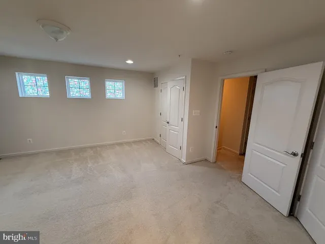 a living room with stainless steel appliances a wooden floor