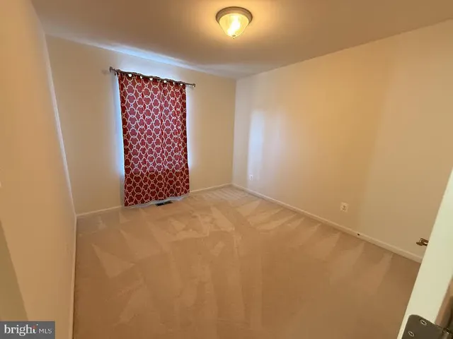 a view of kitchen with stainless steel appliances granite countertop cabinets and wooden floor