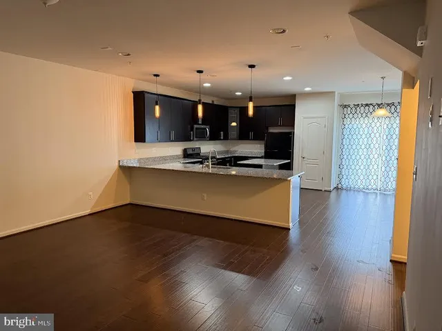 a view of an empty room with closet and a window