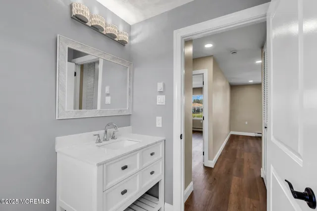 a bathroom with a sink a mirror and a shower