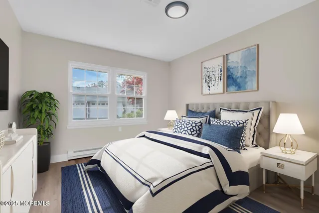 a bedroom with a bed and a potted plant on dresser