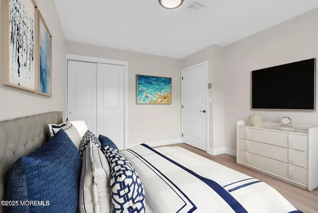 a bedroom with furniture and a flat screen tv