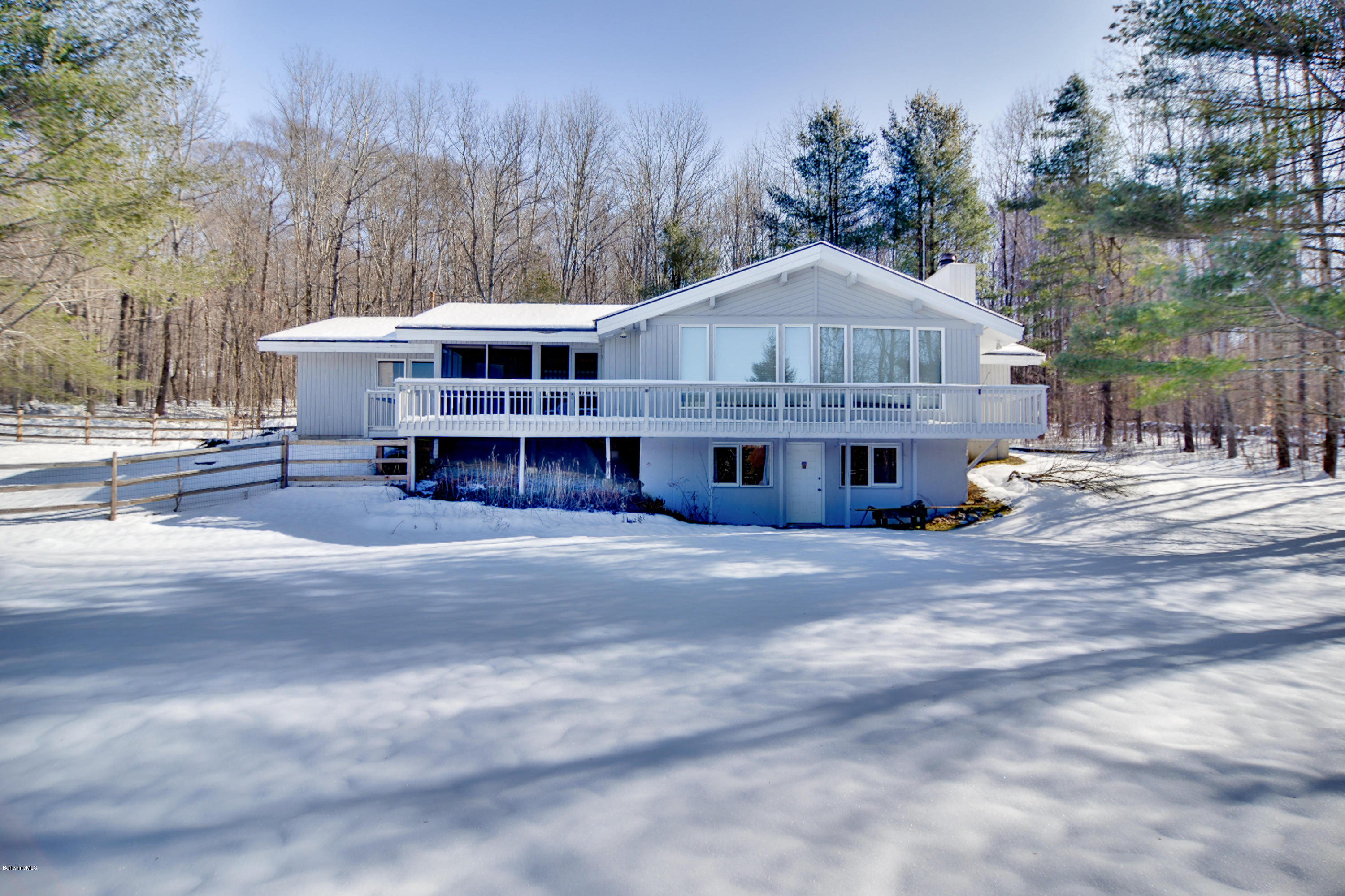 137 Whitman Road Hancock, MA 01267 - Photo 1 of 37 a front view of a house with a garden and trees
