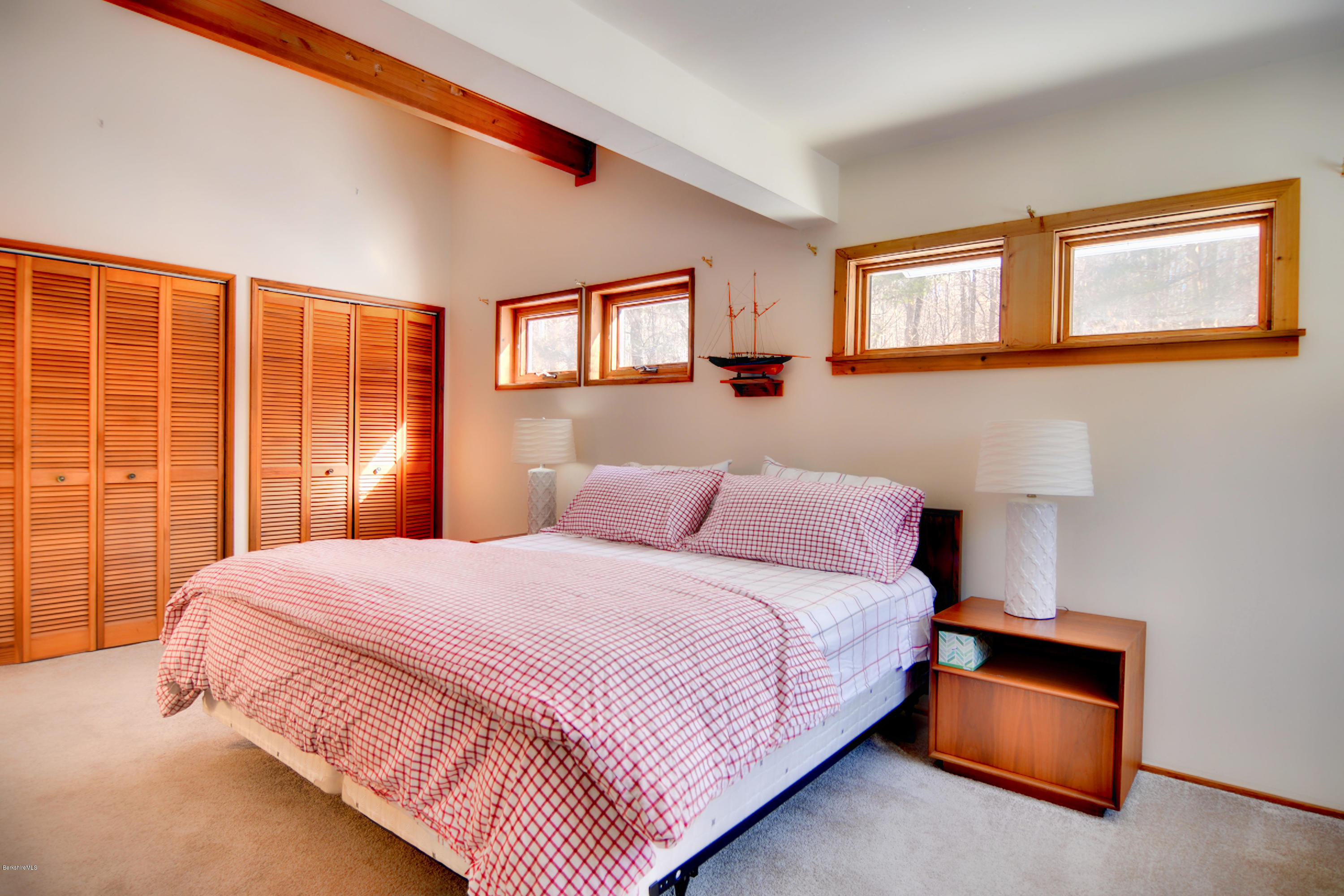 137 Whitman Road Hancock, MA 01267 - Photo 24 of 37 a bedroom with a bed and a lamp