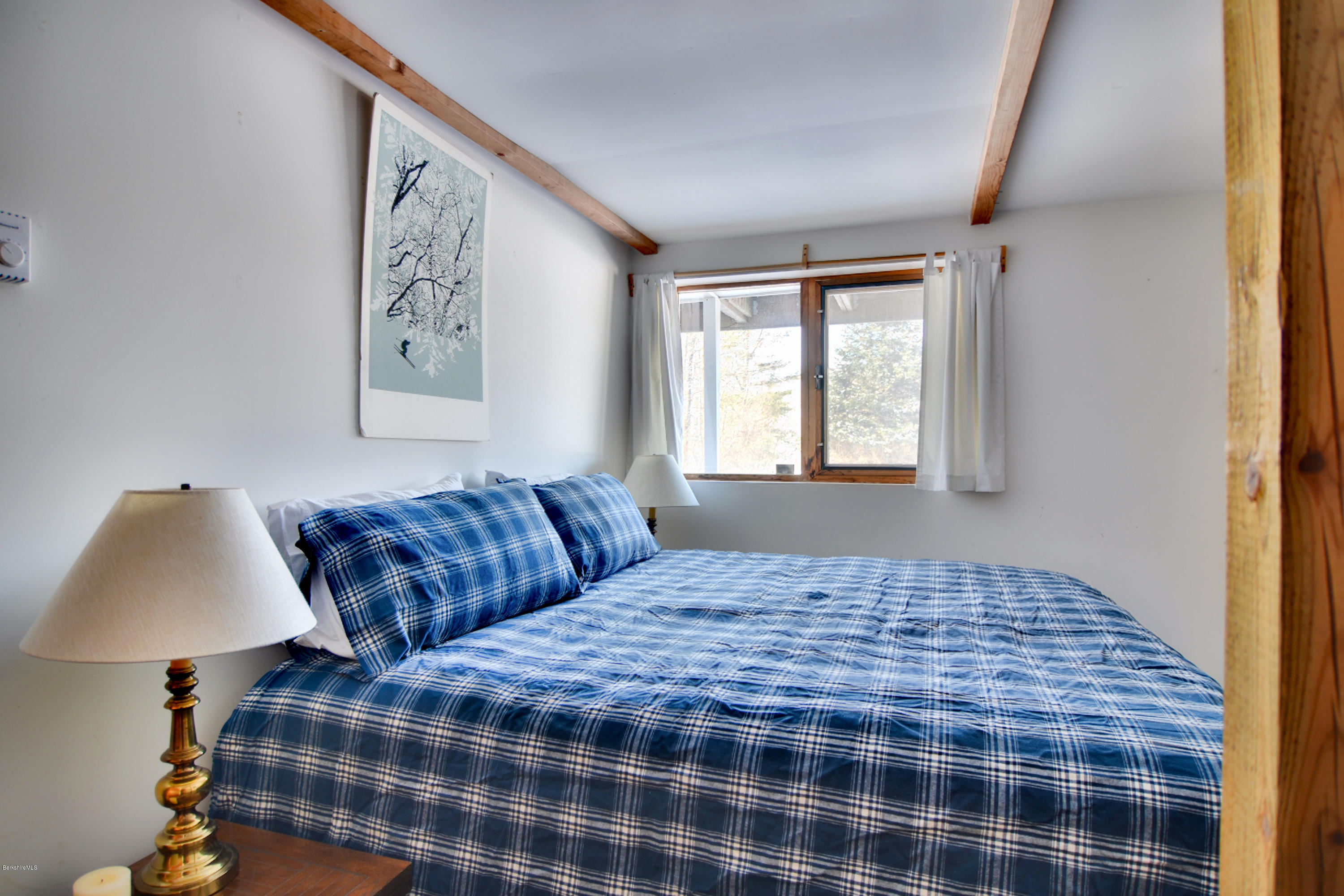 137 Whitman Road Hancock, MA 01267 - Photo 33 of 37 a bedroom with a bed and a lamp next to a window