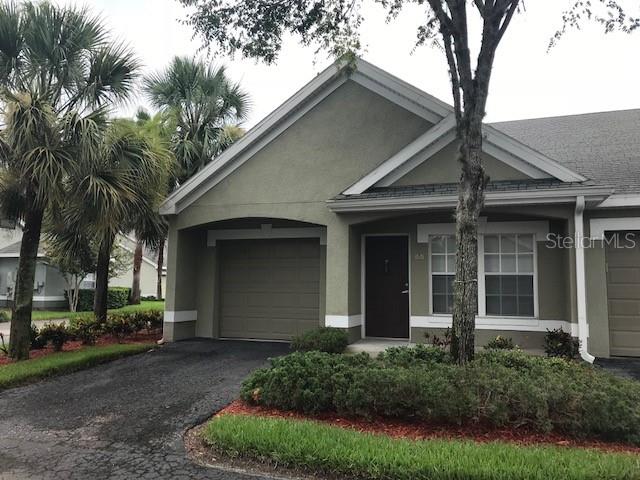 3605 Kings Road, Unit 101 Palm Harbor, FL 34685 - Photo 1 of 1 a front view of a house with garden