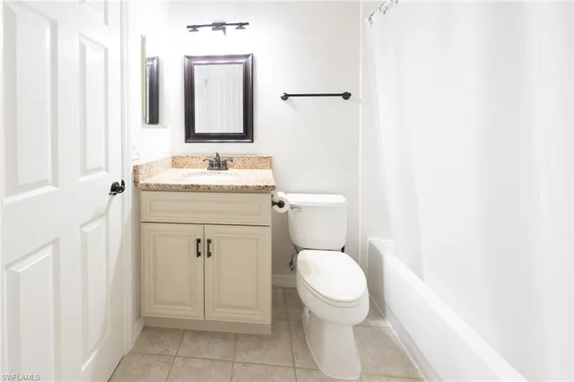 a white toilet sitting next to a bathroom sink