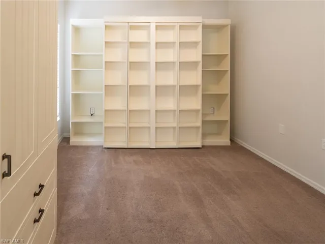 a view of an empty room with empty shelves