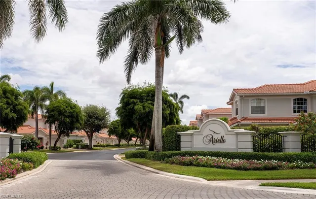 a front view of multi story residential apartment building with yard and green space