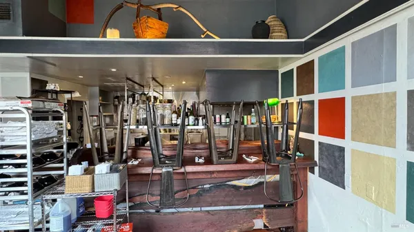 a view of gym equipment with wooden floor
