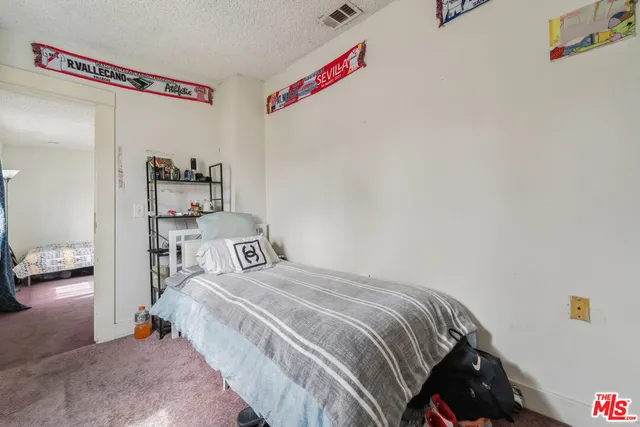 a bedroom with a bed and a cabinets