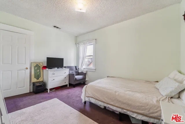 a bedroom with a bed and furniture