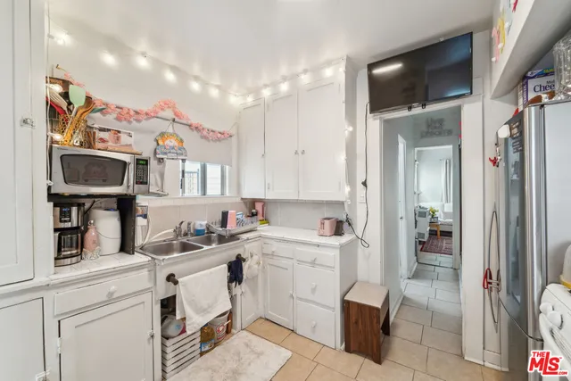 a kitchen with a sink cabinets and utility room
