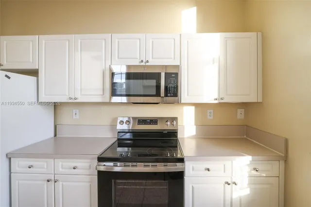 a kitchen with a refrigerator sink and stove