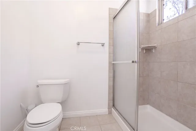 a white toilet sitting next to a white tub