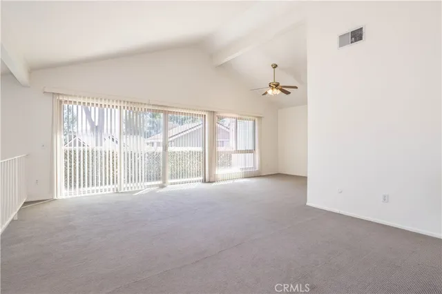 a view of staircase with lots of frames on wall and a window