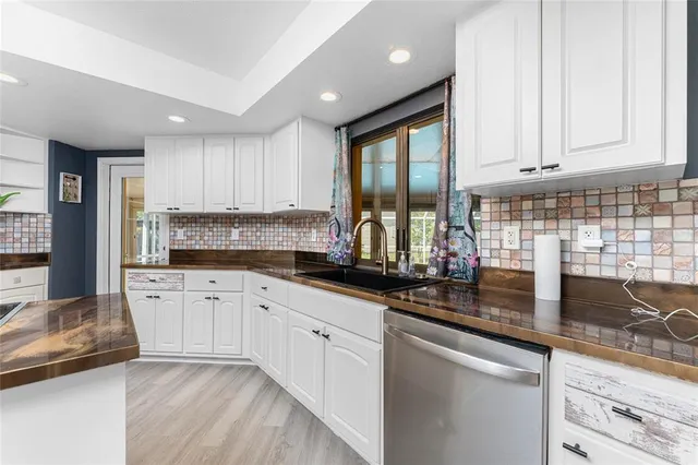 a view of a livingroom with a fireplace a chandelier and stairs