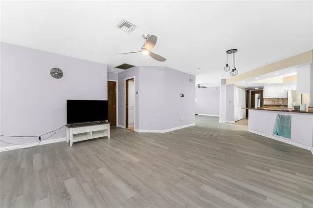 a kitchen with white cabinets and appliances