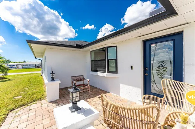 a balcony with furniture and a potted plant