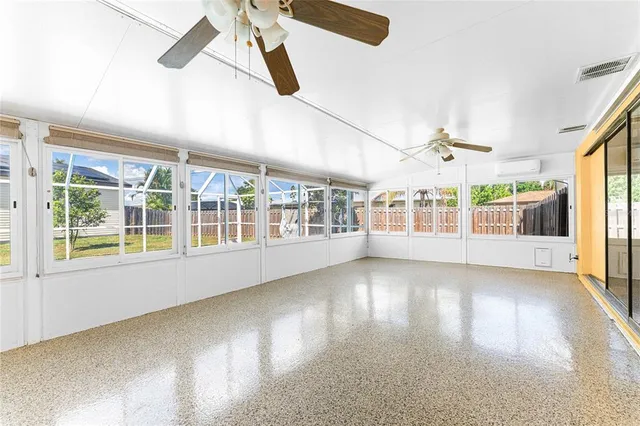 a view of an entryway with wooden floor and windows