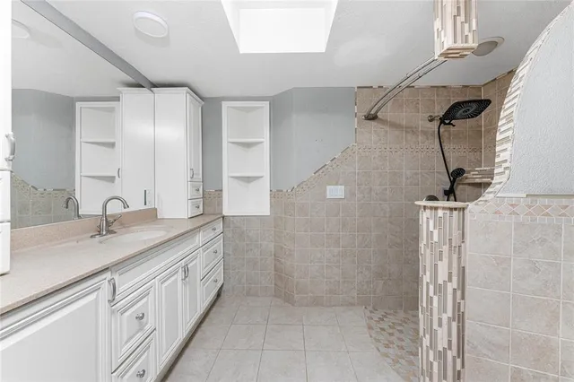 an empty room with wooden floor ceiling fan and windows