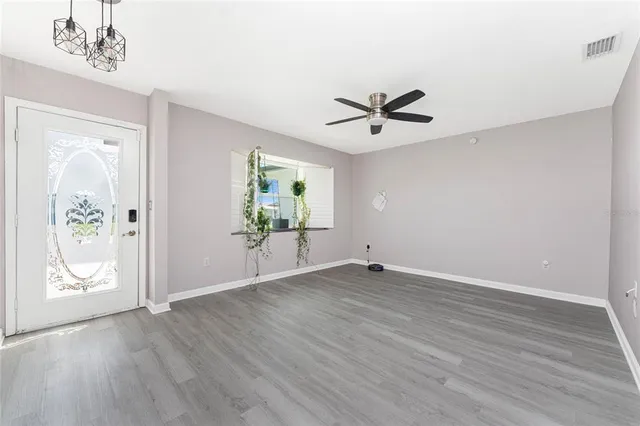 wooden floor in an empty room with a window