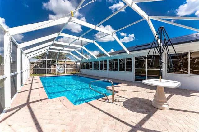 a view of a house with a yard and large trees