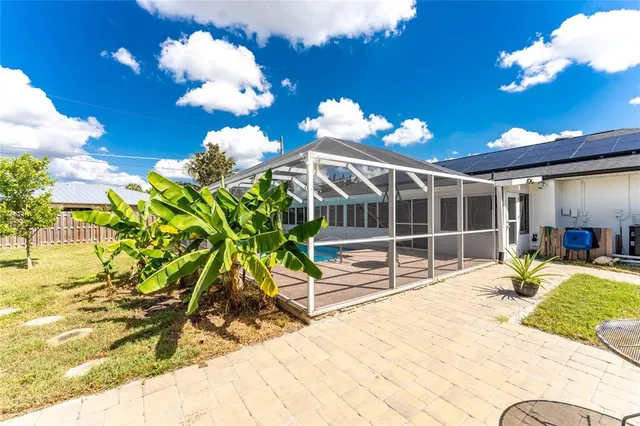 an aerial view of residential houses with outdoor space and swimming pool