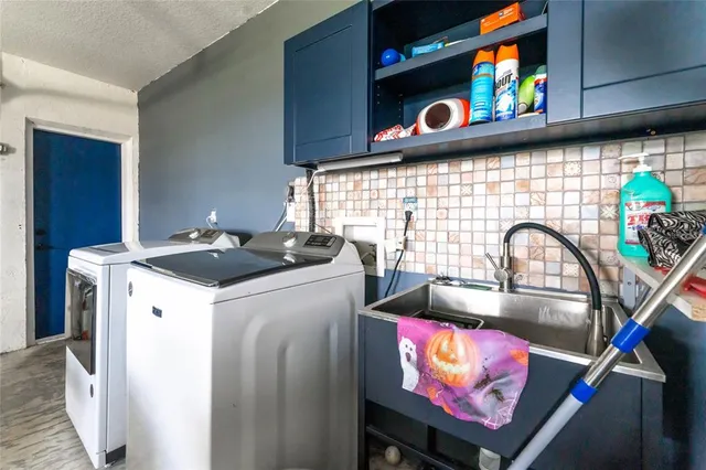 a view of a city with lots of trees and houses with swimming pool