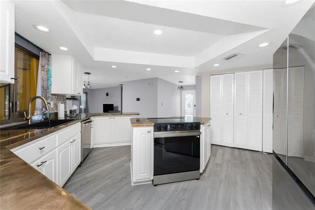 a kitchen with granite countertop white cabinets and white appliances