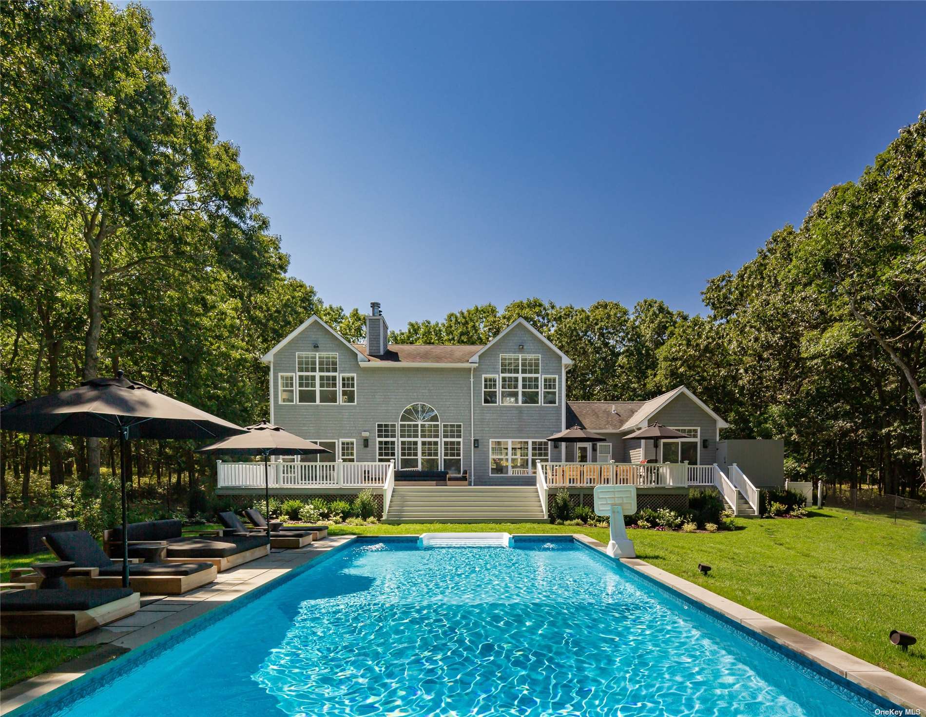 a view of a house with swimming pool and porch