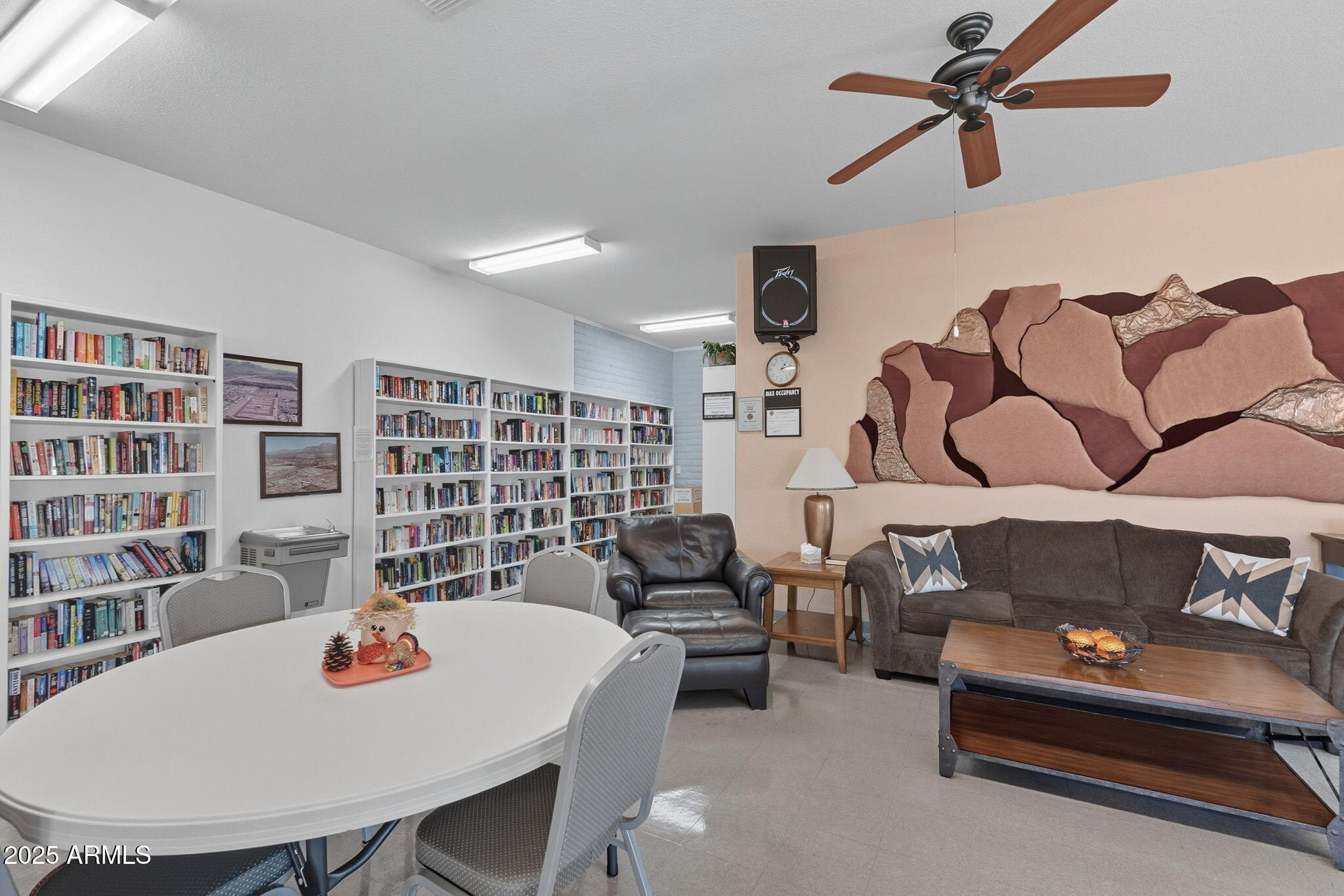 3700 South Tomahawk Road, Unit 39 Apache Junction, AZ 85119 - Photo 47 of 53 a living room with furniture and a book shelf